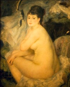 Femme nue assise sur un canapé